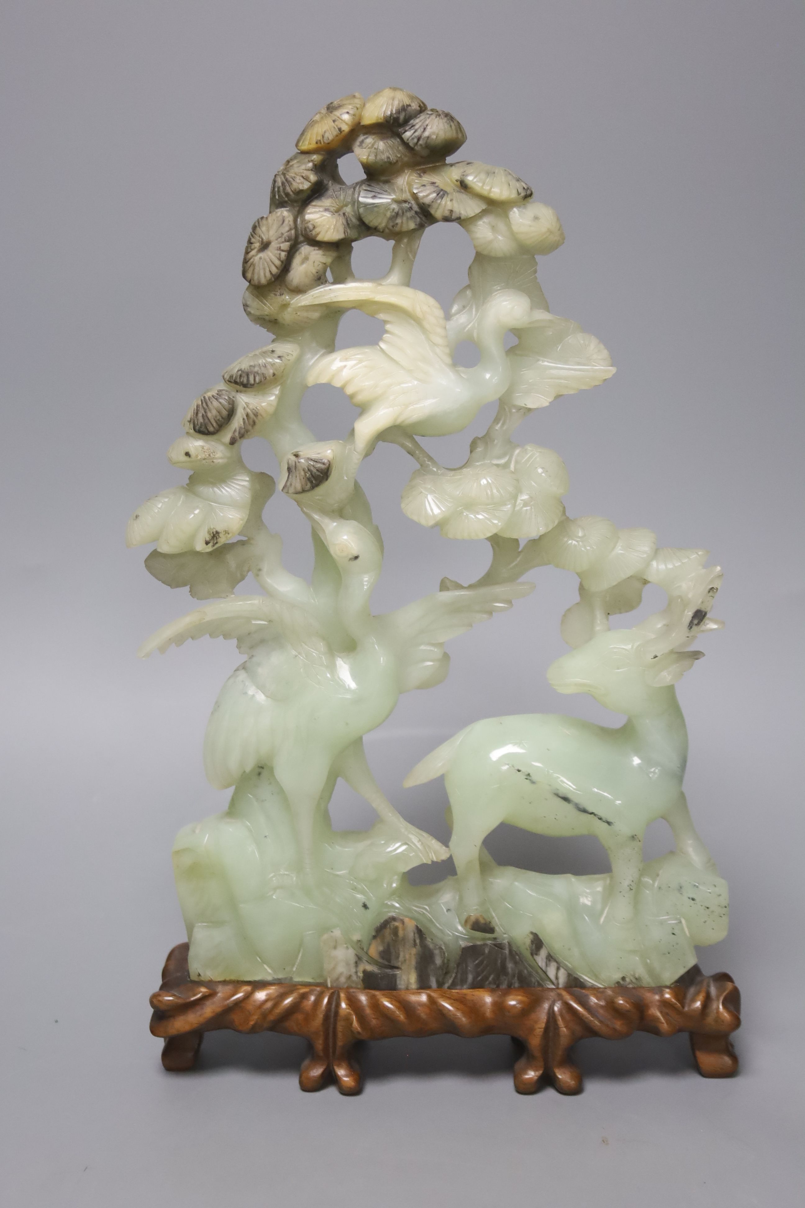 A pair of Chinese bowenite carvings of exotic birds on a branch and four Chinese hardstone items,